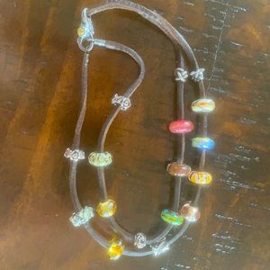 Troll beads with leather wrap and clasp.